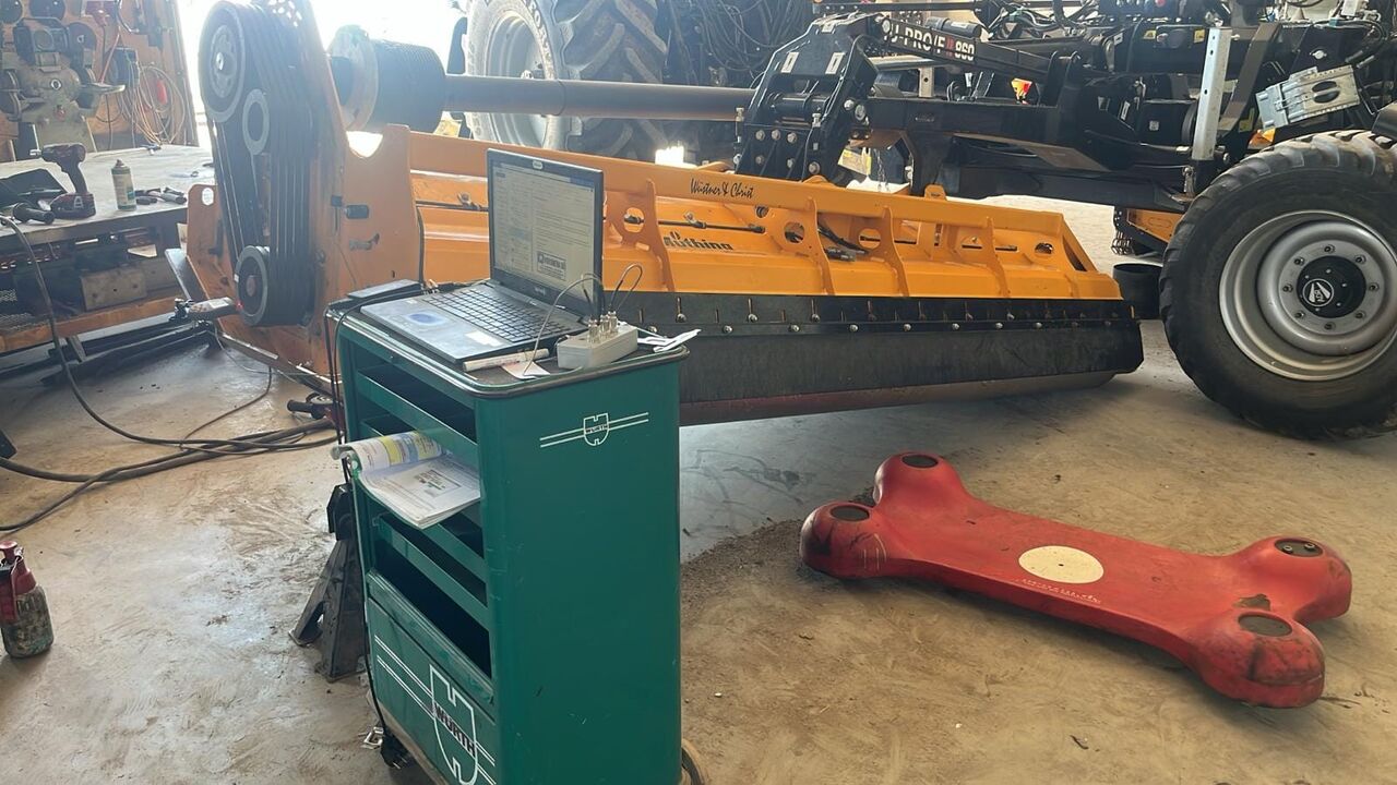 Balanset-1A balancing instrument in action during mulcher balancing