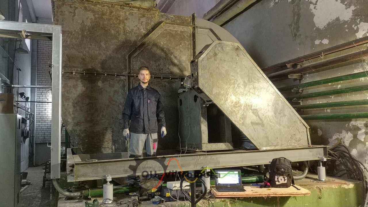 Engineer performing field balancing of industrial fan using portable equipment